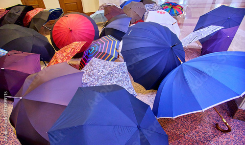 A pile of student colourful umbrellas in a hall of Moscow state university building in autumn