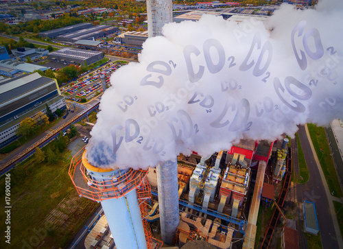 Aerial view to smoking chimmney from lignite power plant. Digital artwork on air pollution and climate change theme. Heavy industry from above. photo