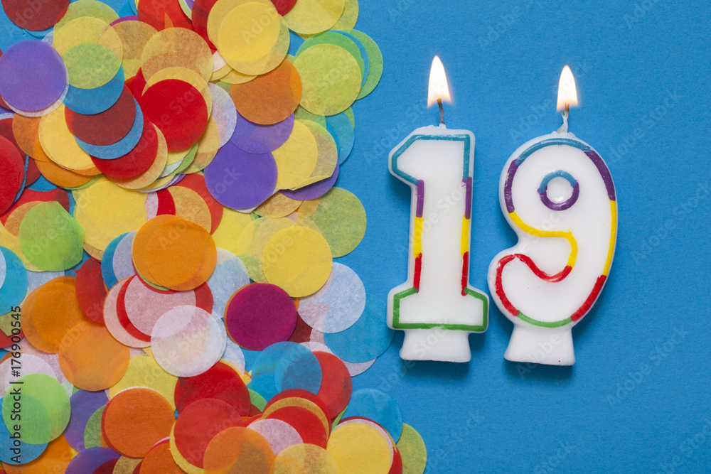 Number 19 celebration candle with party confetti Number 19 celebration candle with party confetti