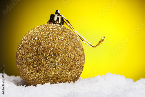 Christmas composition of Christmas tree toys on a yellow background