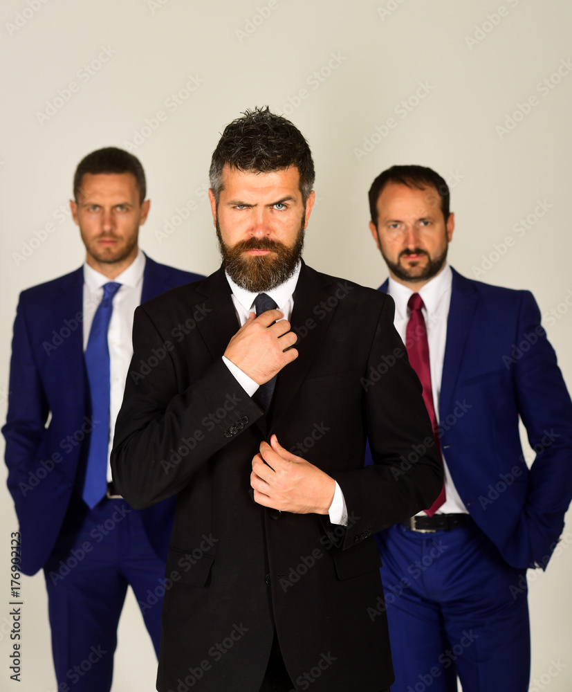 Men with beard and strict faces stand for partnership