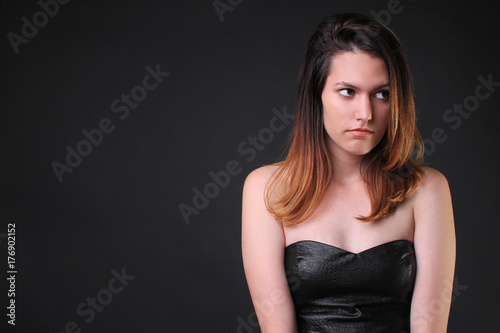 Seductive girl in a black dress bored