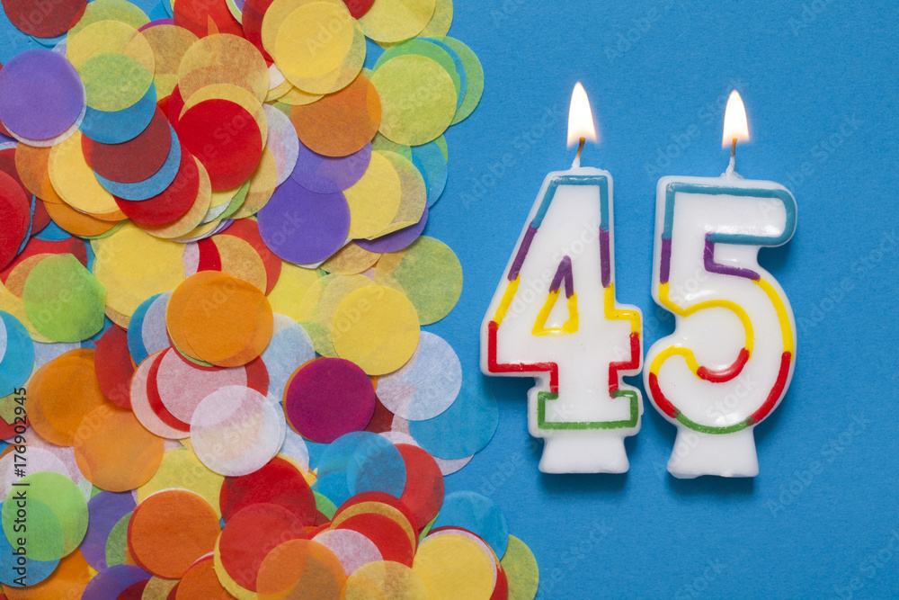 Number 45 celebration candle with party confetti