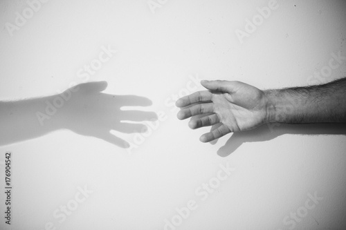 Hands reaching shadow