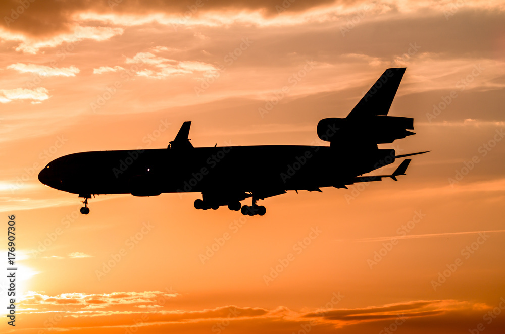 Airplane landing at sunset Airplane landing at sunset