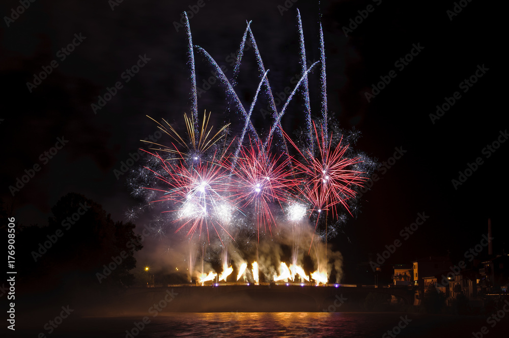 fireworks launched from a bridge on Adige river near Verona and