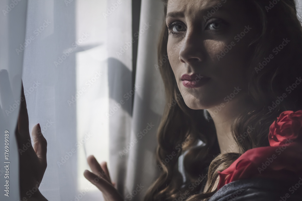 pretty girl at the window looking directly at the camera, mood pretty girl at the window looking directly at the camera, mood