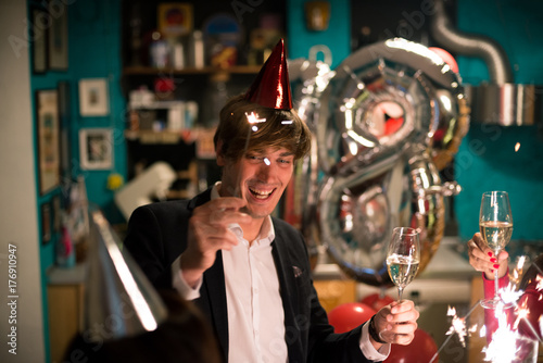 Photography Young adult man celebrating with friends new year eve or eighteenth birthday in