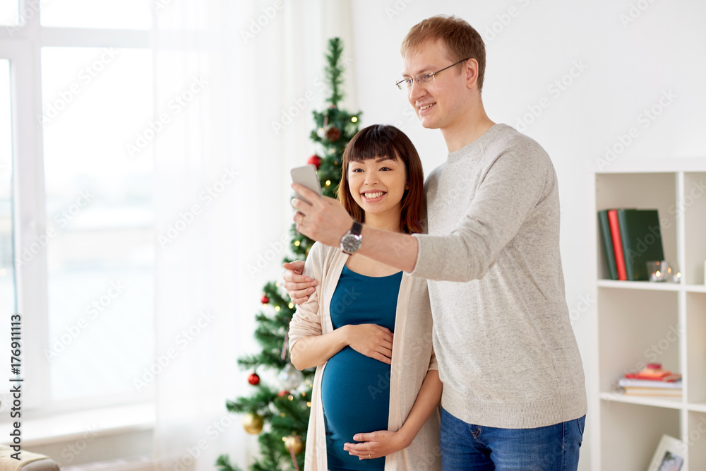 happy family couple taking selfie at christmas happy family couple taking selfie at christmas