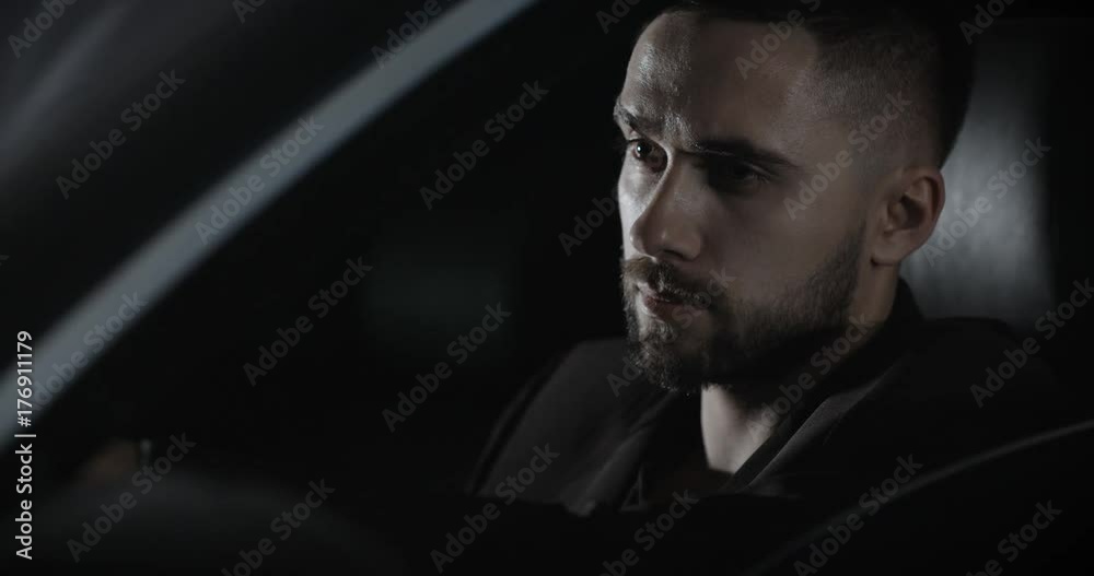 Close up successful businessman siting in expensive car Close up successful businessman siting in expensive car