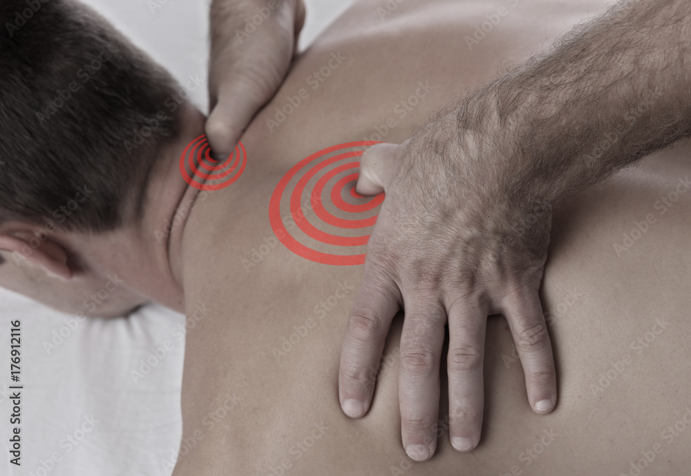 Fototapeta premium Chiropractic, osteopathy, manual therapy, acupressure. Therapist doing healing treatment on man's back. Alternative medicine, pain relief concept