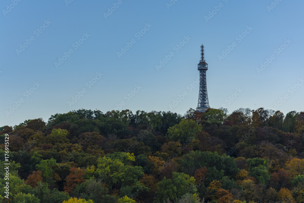 The Petrin tower is lighting during sunny day. Day view on Prague. The Petrin tower is lighting during sunny day. Day view on Prague.