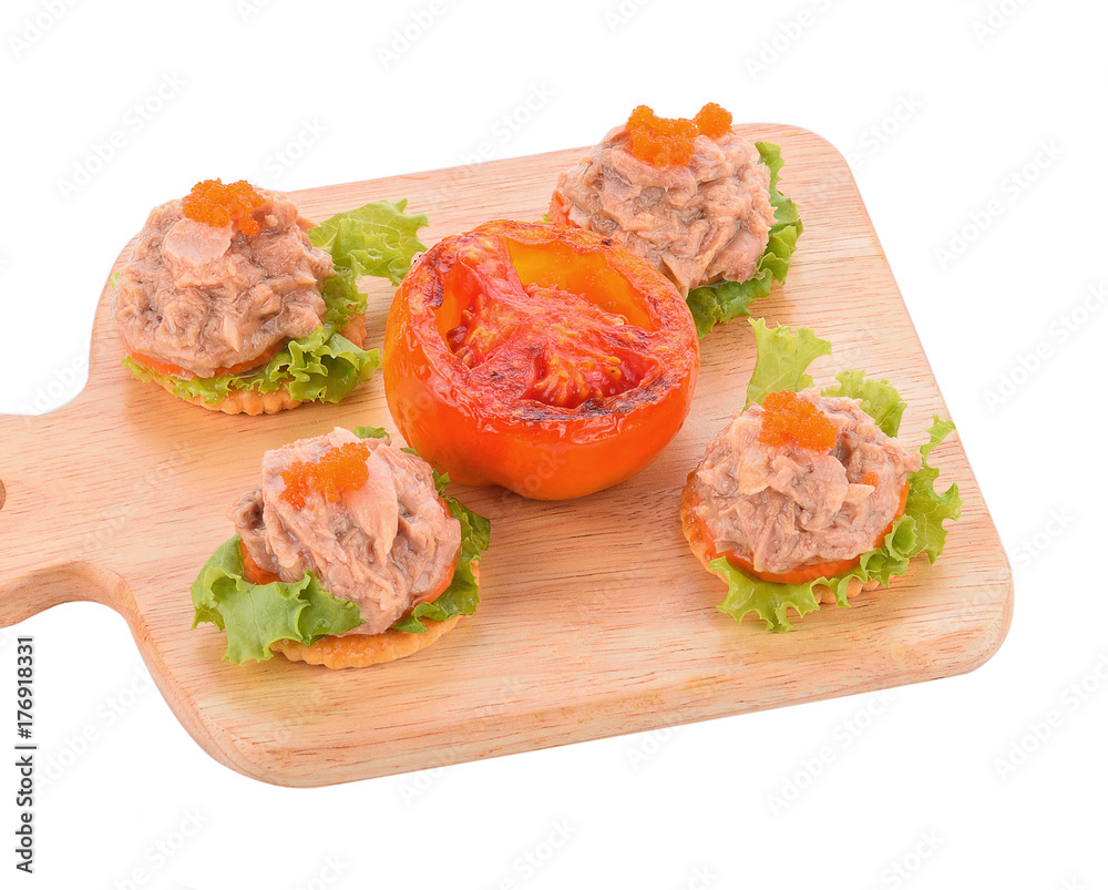 Tuna salad on a biscuit on a white background. Tuna salad on a biscuit on a white background.