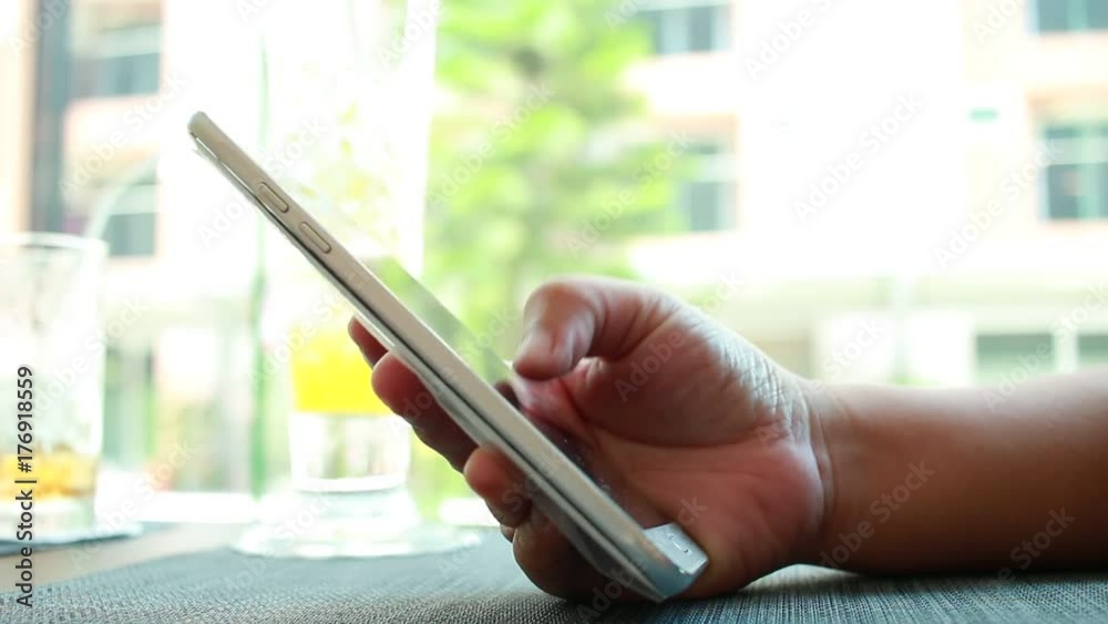 Businesswoman holds Using Online banking payment by network internet wireless development mobile smartphone and tablet sync app with stylus pen for Business shopping in coffee shop, Internet concept