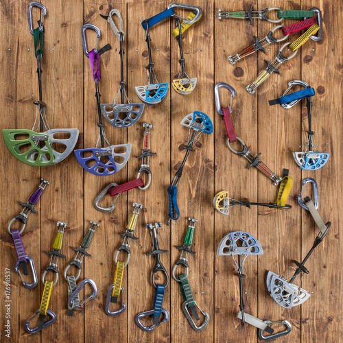 Differently sized climbing camalots on a wooden floor photo