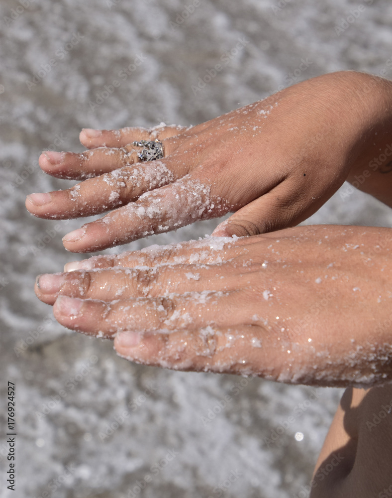 Fototapeta premium Salt on the girl's hands