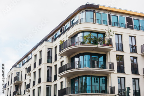 white facaded modern building with curved balcony
