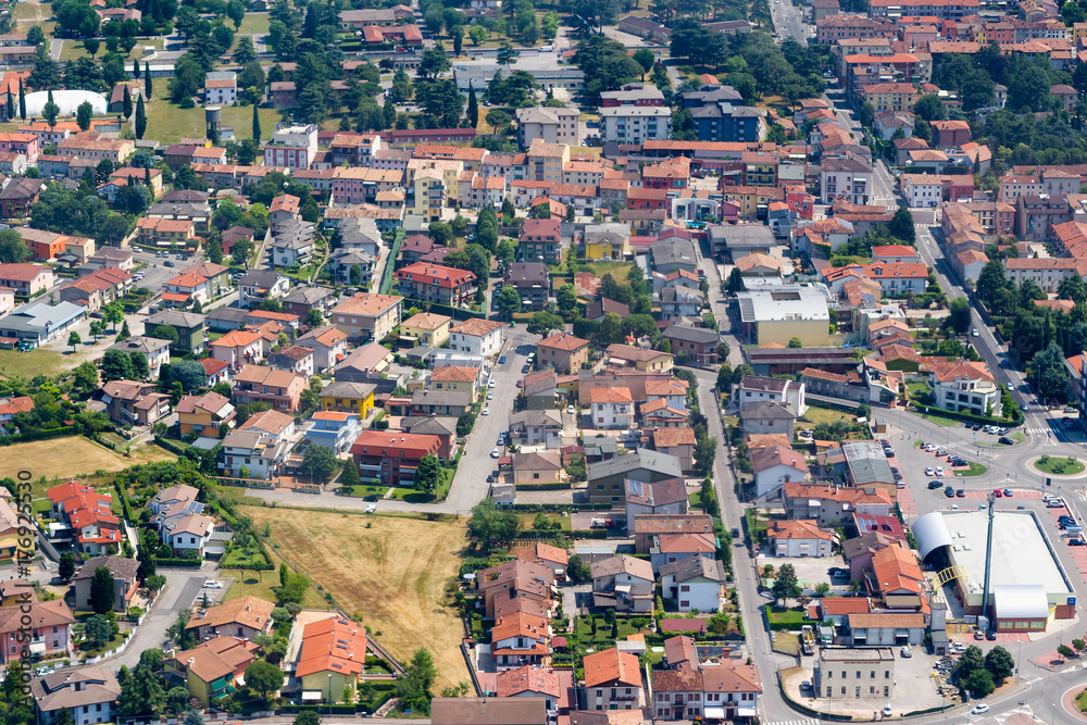 City aerial view over the Veneto region, Italy. Aerial view of typical houses with red roofs at residential Europe district in summer day. Сityscape