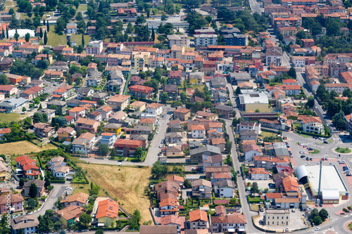 City aerial view over the Veneto region, Italy. Aerial view of typical houses with red roofs at residential Europe district in summer day. Сityscape