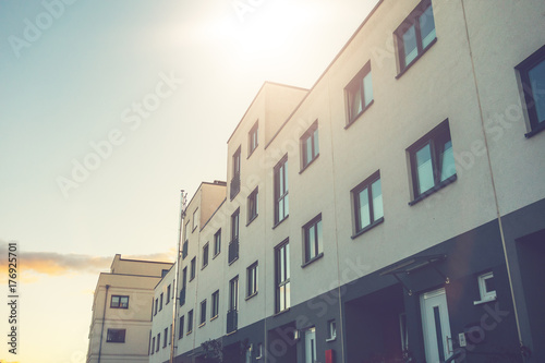 white townhouses with warm sunlight in the middle of the picture © Robert Herhold