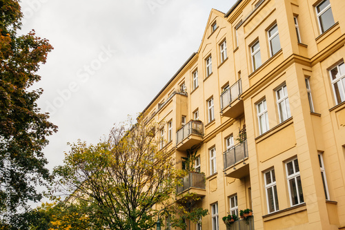 orange apartment building with autumn trees