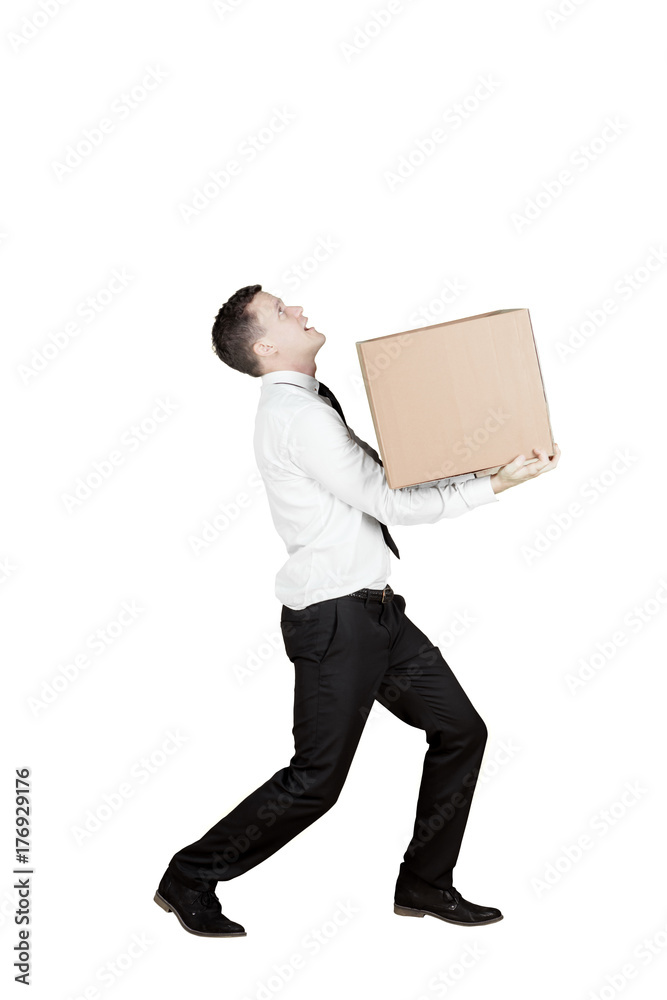 European businessman carrying a box on studio European businessman carrying a box on studio