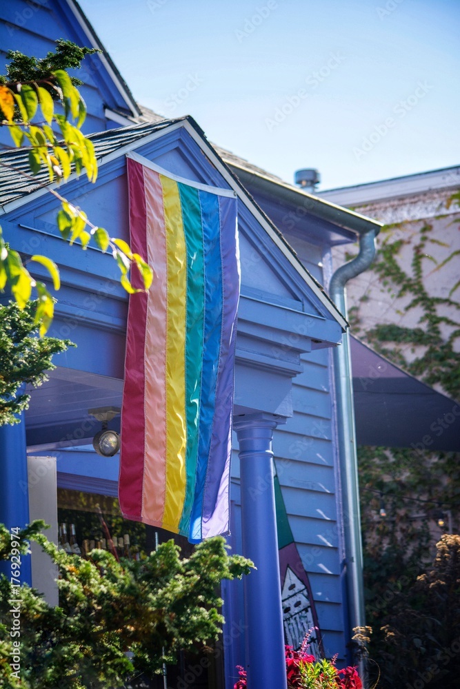 Rainbow colored pride flag hang from the enterance of a business Stock ...