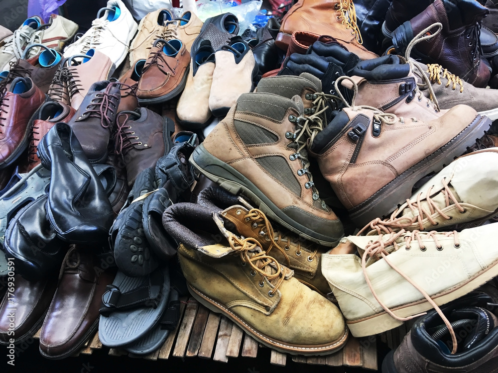 Pile of second hand shoes on shelf at weekend market. Stock Photo | Adobe  Stock