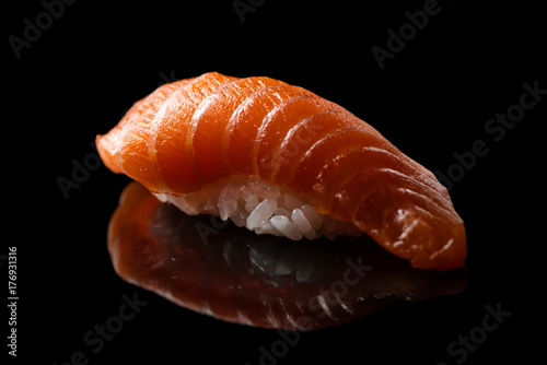 Closeup composition of fresh salmon sashimi sushi on a dark background