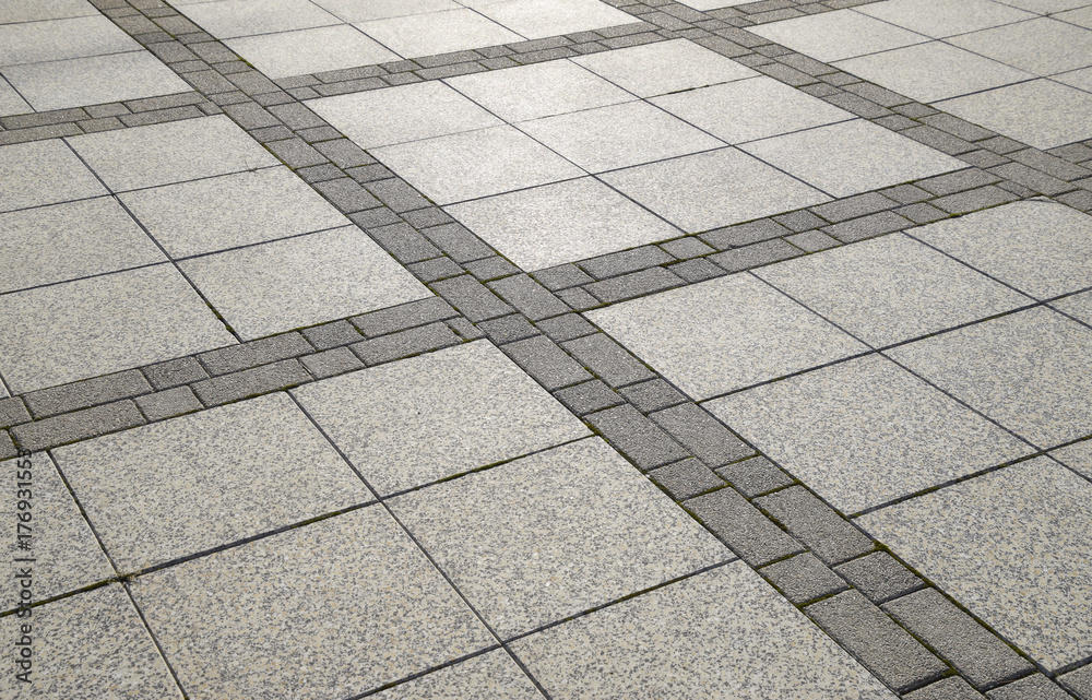 Fototapeta premium Figure out the paving slabs in the square. Background of paving