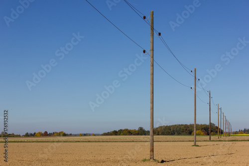 Принти на полотні telegraph pole beside a bikeway and white tower on a plain field and wide horizo