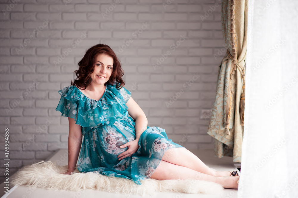Fototapeta premium Happy pregnant woman with a beautiful smile.