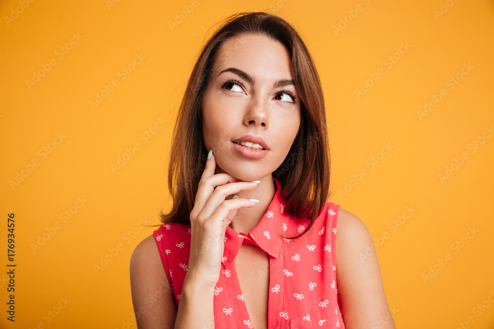 Close-up photo of cute thoughtful young woman, touching her chin, looking upward Close-up photo of cute thoughtful young woman, touching her chin, looking upward