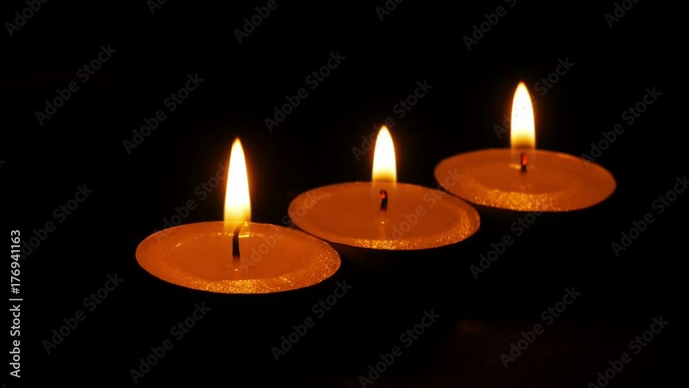 dolly,Close up candle is burning on black background. dolly,Close up candle is burning on black background.