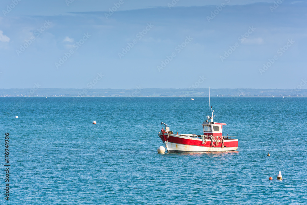 Bright blue sea and a fisherman boat