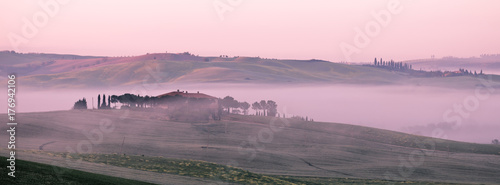 Morning fog view on farmhouse in Tuscany, Italy