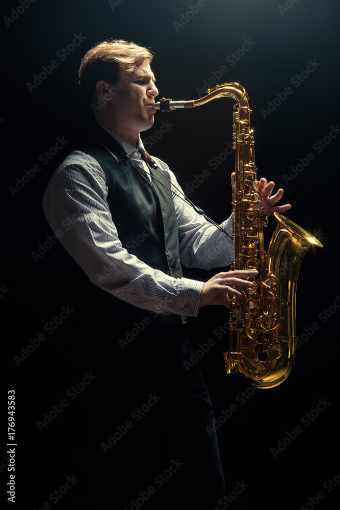 Fototapeta premium Young man playing the Saxophone