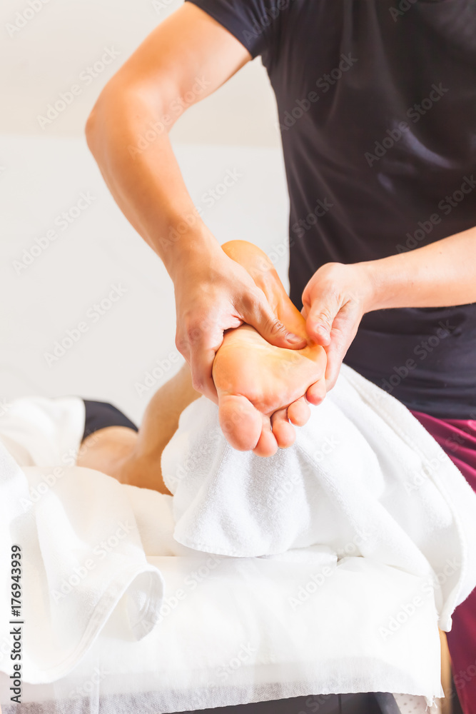 Therapist Giving Leg Massage In Spa manipulation of a calf muscle Therapist Giving Leg Massage In Spa manipulation of a calf muscle