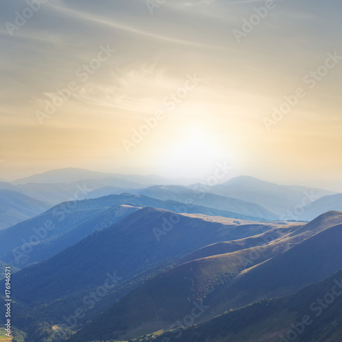 sunset over a misty mountains