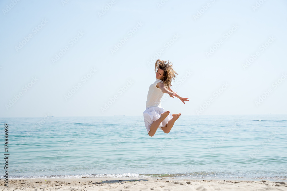 Happy beautiful young girl jumping Happy beautiful young girl jumping