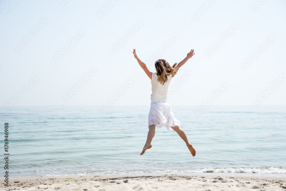 Happy beautiful young girl jumping Happy beautiful young girl jumping