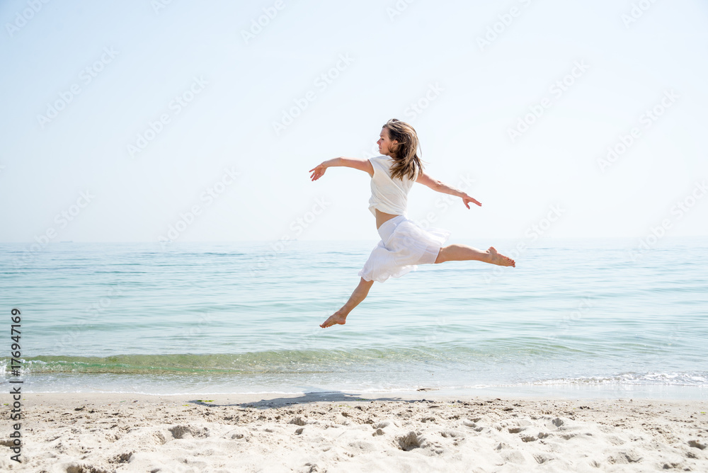 Happy beautiful young girl jumping Happy beautiful young girl jumping
