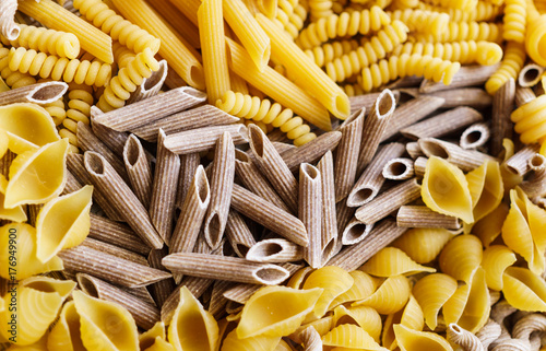 noodles, pasta of different kinds, scattered on the table. photo