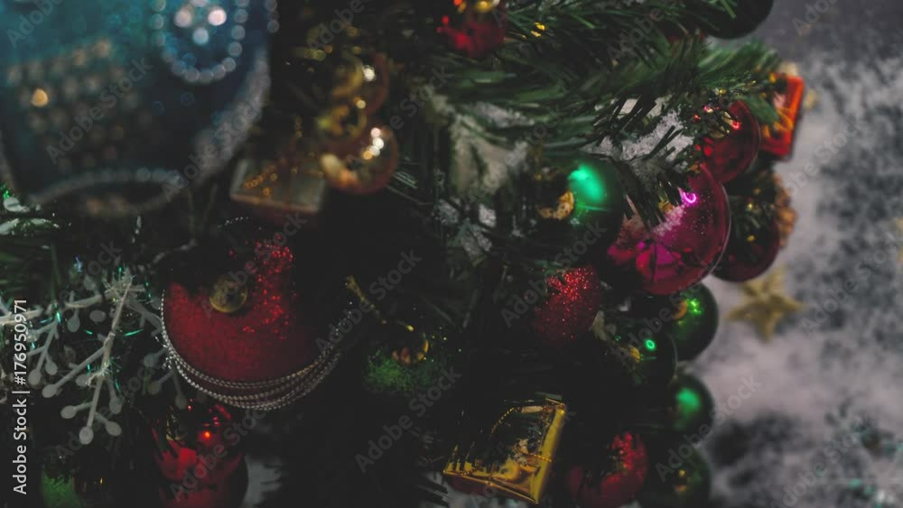 Greeting Season concept.Christmas tree and decorations with presents and ornaments on wood table from above with falling snow in 4k (UHD) Greeting Season concept.Christmas tree and decorations with presents and ornaments on wood table from above with falling snow in 4k (UHD)