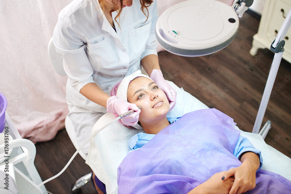 Girl beautician works with patients in the office Girl beautician works with patients in the office