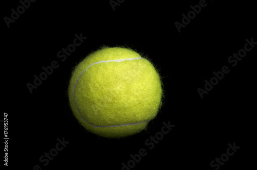 Tennis ball isolated on black background. © sergeyphoto7