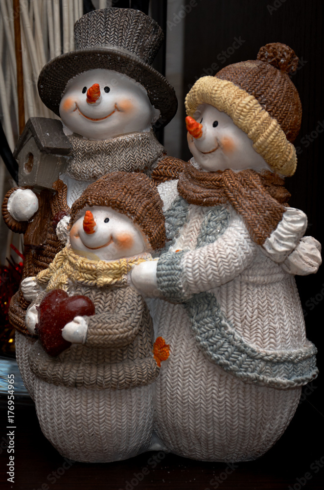 A family of snowmen with a small child. Christmas figurine. A family of snowmen with a small child. Christmas figurine.