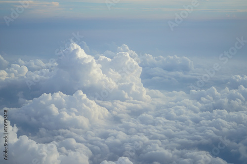 View of beautiful free form heaven white cloud with shades of blue sky background from flying plane window