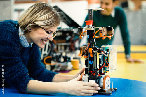 Young engineer testing her robot in workshop