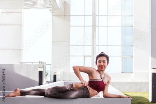 Free Download Woman practicing yoga  in front of a large window - GFXLoad